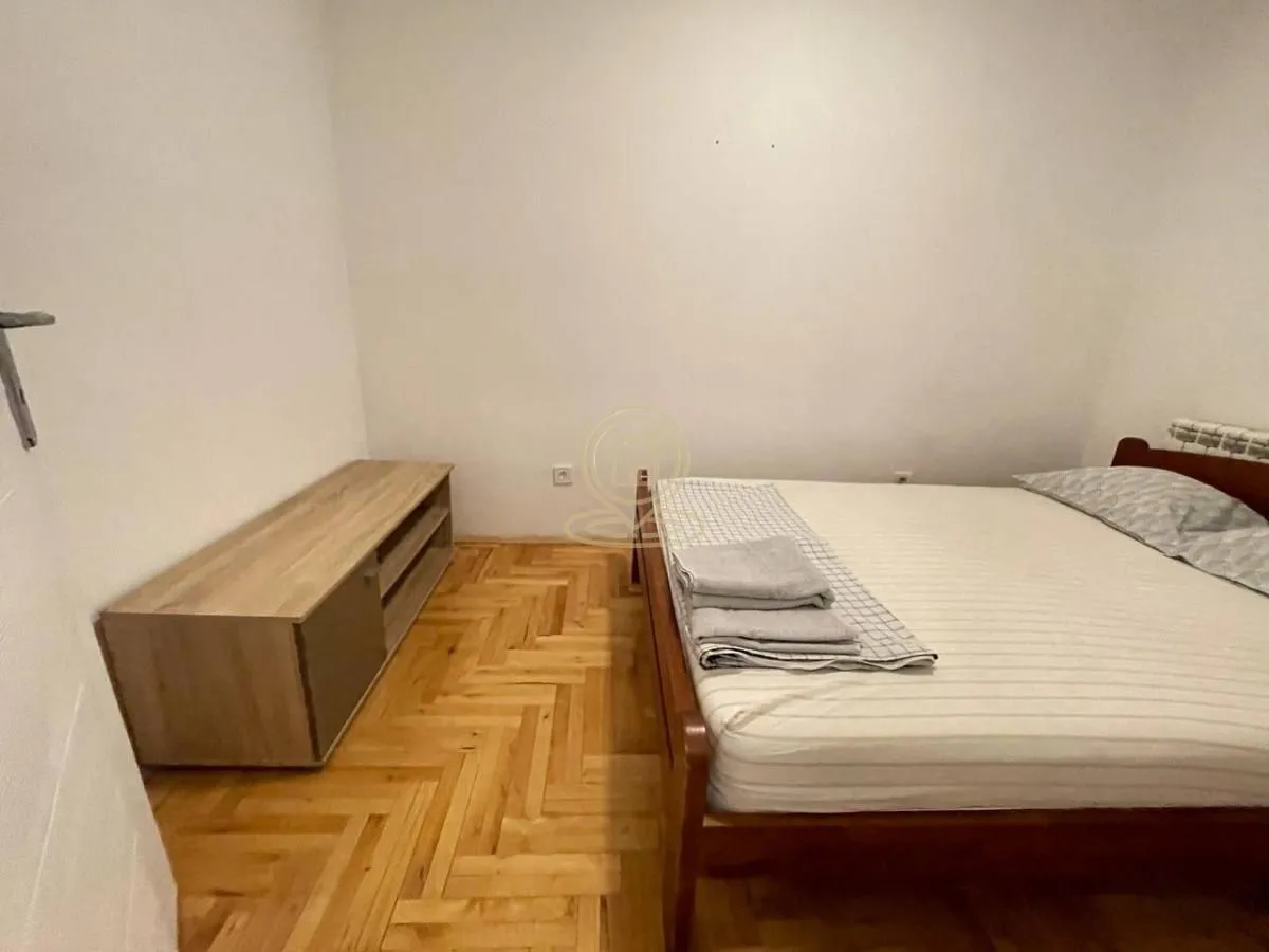 Bedroom with a double bed and wooden flooring.