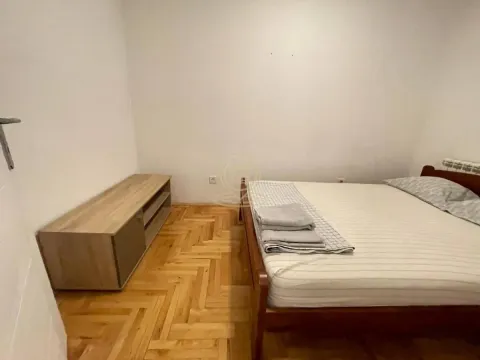 Bedroom with a double bed and wooden flooring. - image 12