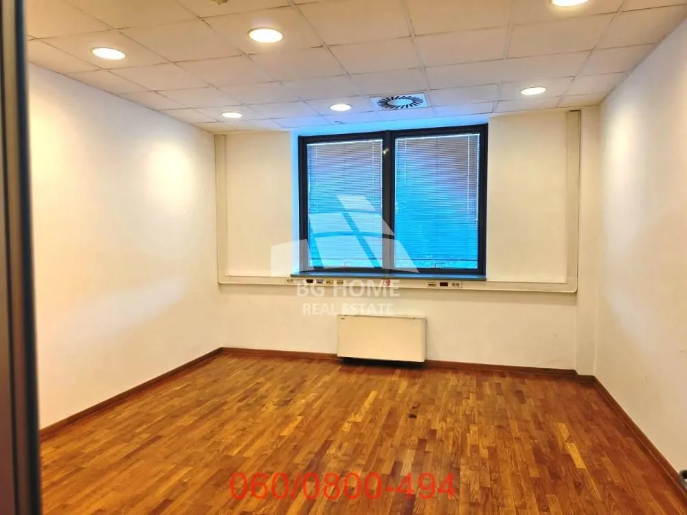 Empty room with hardwood floors and a window.