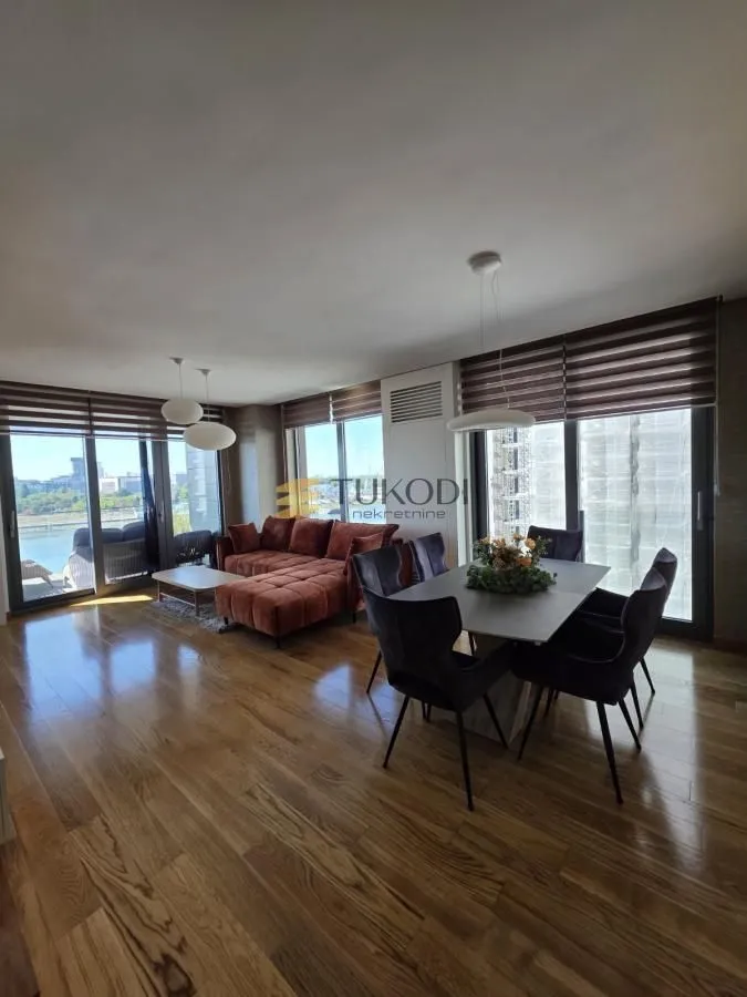 Spacious living room with a dining area and large windows.