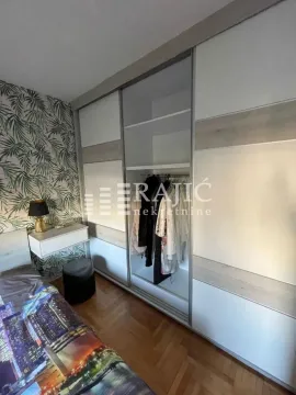 Bedroom with a large built-in wardrobe and a bed. - image 8