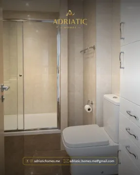 Moderno opremljeno kupatilo sa tuš kabinom i bijelim namještajem. - image 4
