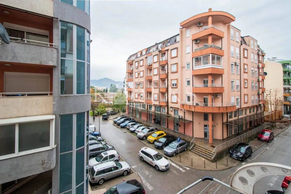 View of surrounding buildings and parking in front of the property.