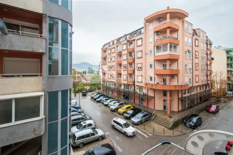 View of surrounding buildings and parking in front of the property. - image 2