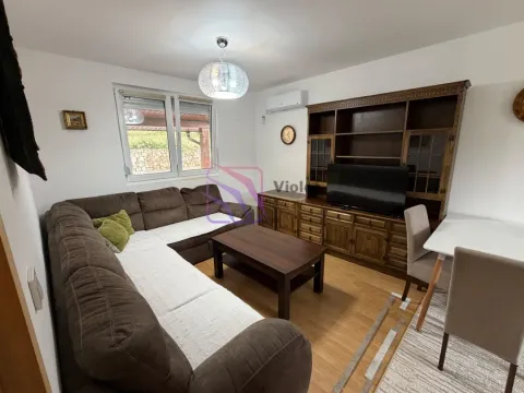 Living room with a sectional sofa, wooden furniture, and a dining table. - image 4