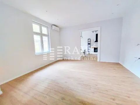 Empty room with laminate flooring and a window, looking into another room. - image 6