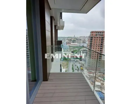 Modern balcony with wooden decking and glass railing offering a city view. - image 2