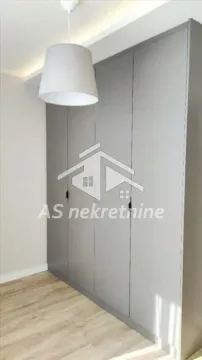 Large grey built-in wardrobe in a bedroom with wooden flooring. - image 14