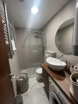Modern bathroom with a shower cabin and sink. - image 8