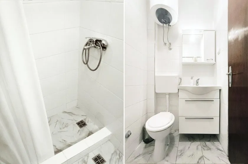 Smaller bathroom with a shower cabin, washbasin, and toilet.