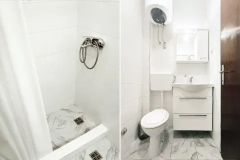 Smaller bathroom with a shower cabin, washbasin, and toilet. - image 9