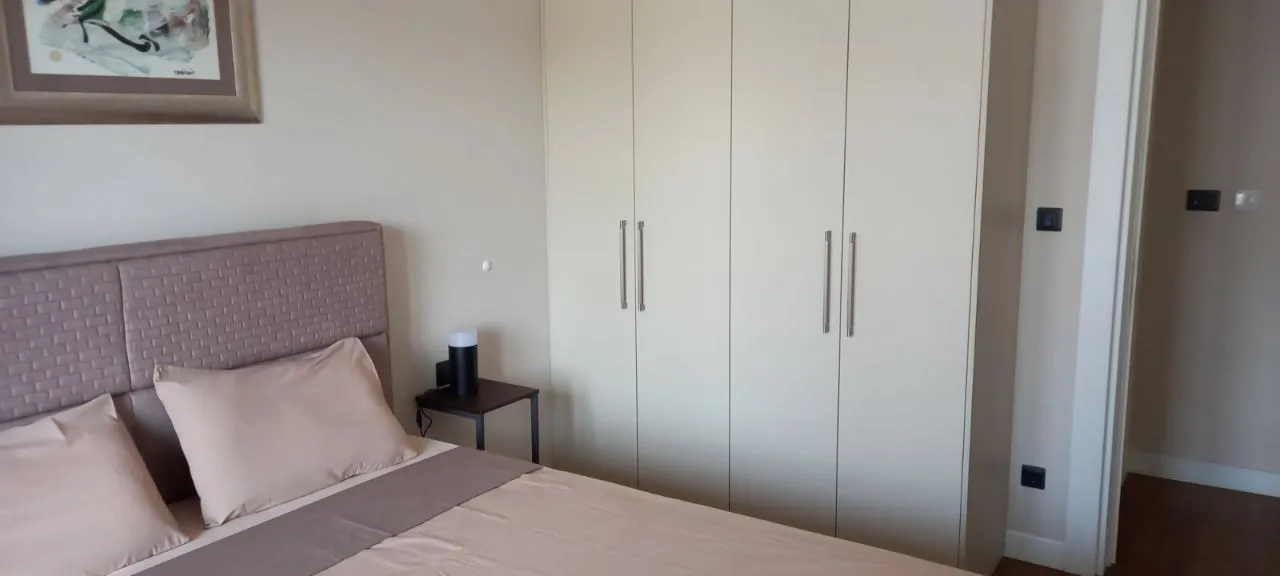Furnished bedroom with a double bed and built-in wardrobe.