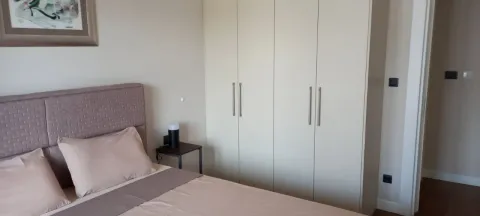 Furnished bedroom with a double bed and built-in wardrobe. - image 2