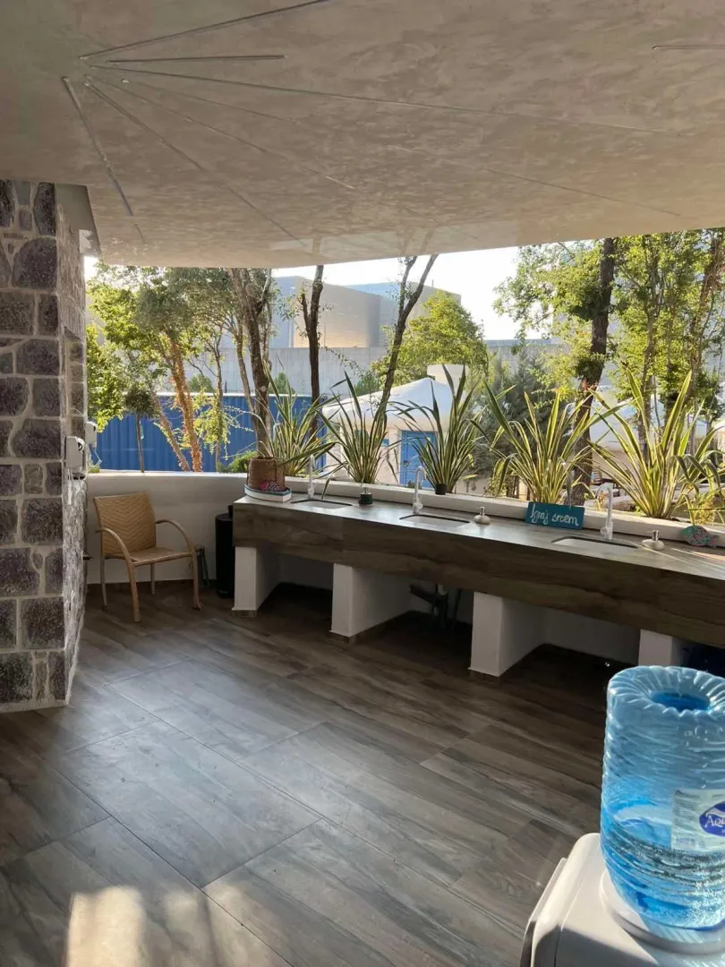 Covered terrace with a long work counter and sinks.