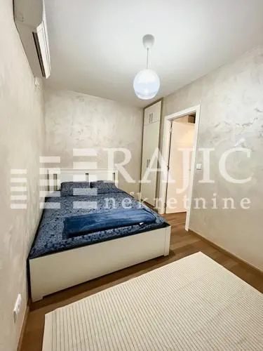 Small bedroom with a double bed, wardrobe, and air conditioning.