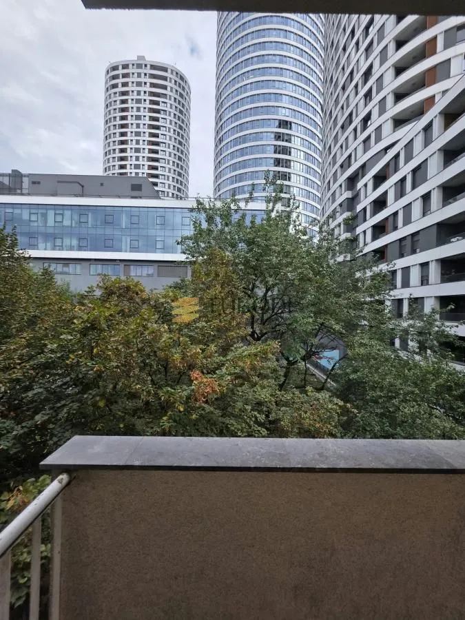 View from the terrace towards surrounding residential buildings and greenery.