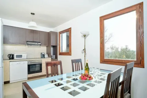 Dining area with a table and chairs overlooking the kitchen. - image 19