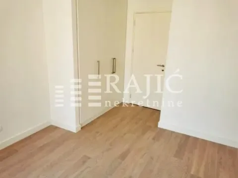 Empty room with a built-in wardrobe and wooden floor. - image 4