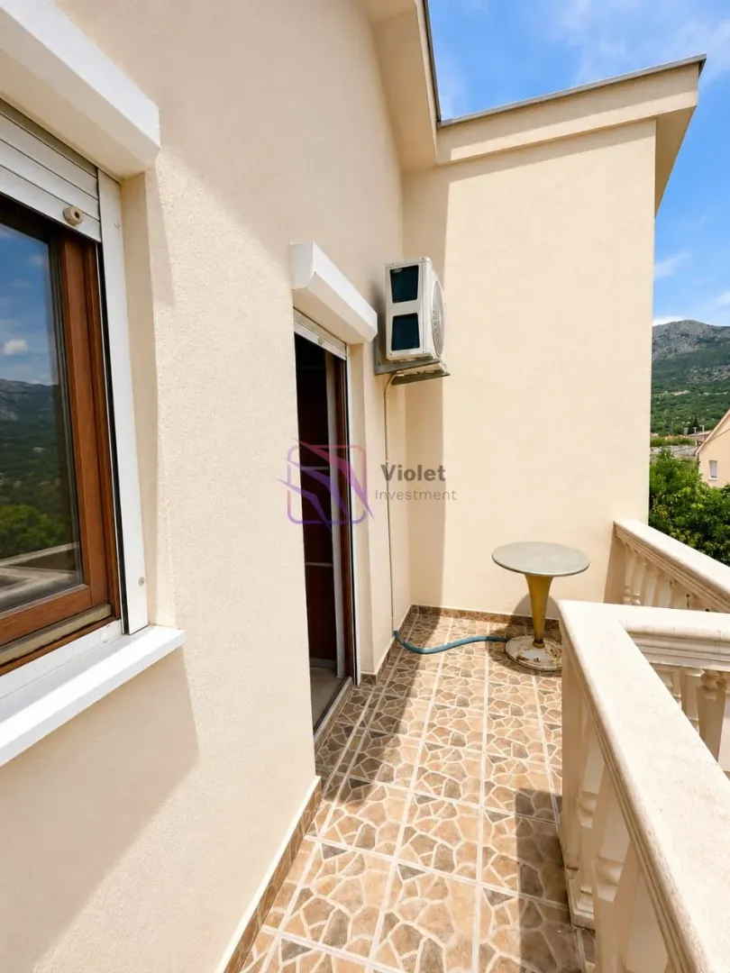 Spacious balcony with ceramic tiles and surrounding views.