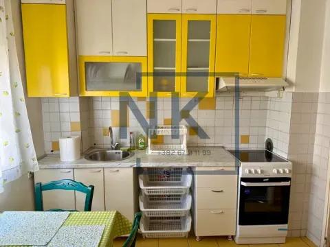 Small kitchen with yellow and white cabinets and a stove. - image 4