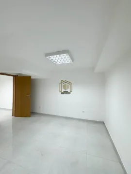 Empty room with white walls, tiled flooring, and an open wooden door. - image 12