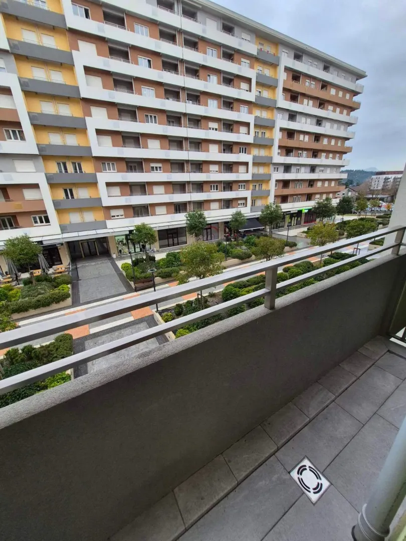 View from the balcony overlooking the landscaped courtyard and neighboring building.
