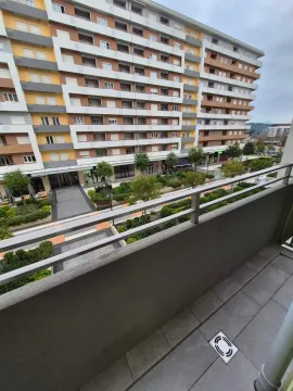 View from the balcony overlooking the landscaped courtyard and neighboring building. - image 2