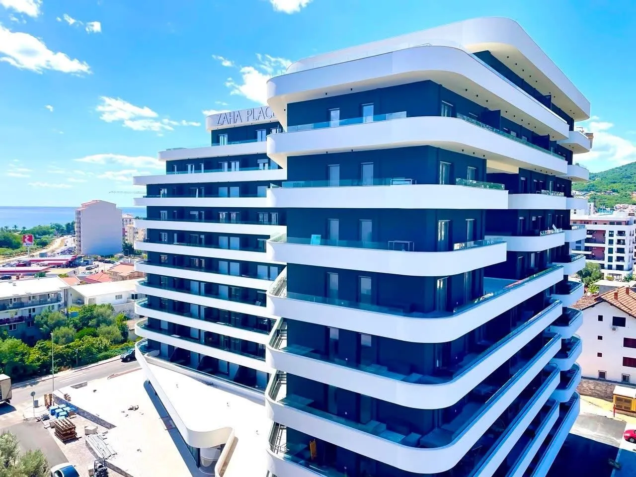 Exterior of a modern multi-story residential building with terraces.