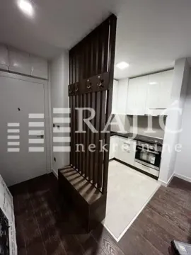 View of a modern kitchen with a wooden partition in the hallway. - image 7