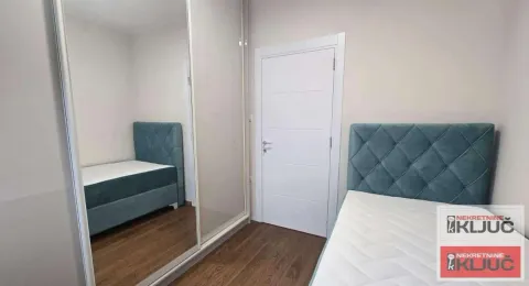 Bedroom with a bed and a large mirrored wardrobe. - image 5