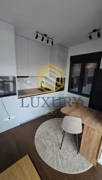 Modern kitchen with a dining table and chairs. - image 4