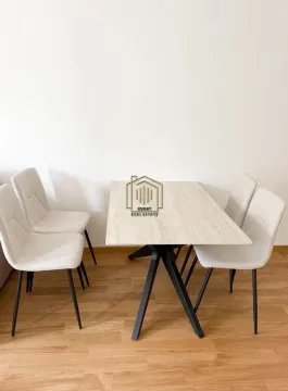 Dining table with four chairs on a wooden floor. - image 4