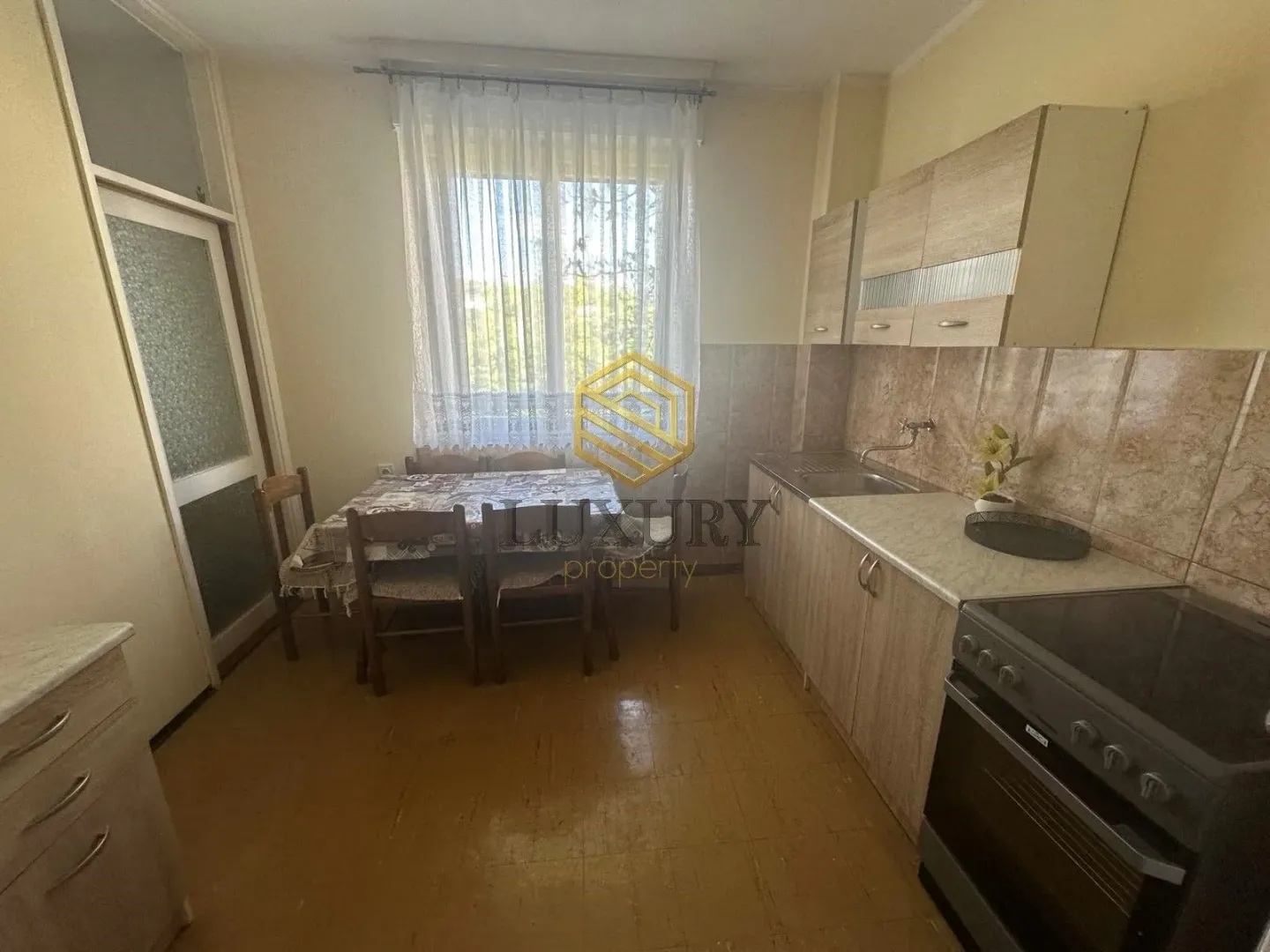 Small kitchen with a dining table and kitchen cabinets.