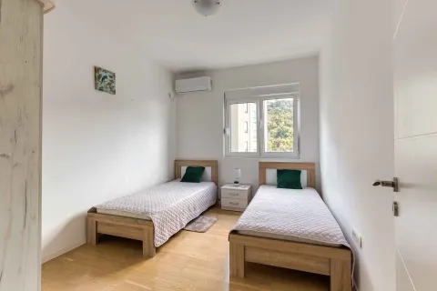 Bedroom with two single beds and air conditioning. - image 15