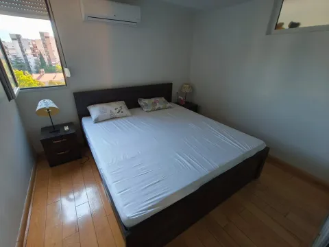 Bedroom with a double bed, bedside tables, and a window. - image 15