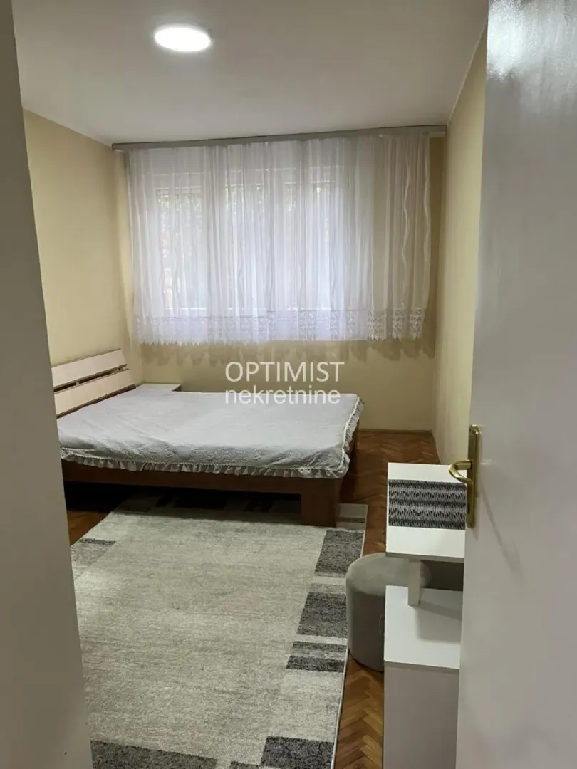 Bedroom with a bed and a window.