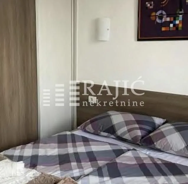 Furnished bedroom with a double bed and built-in wardrobe.