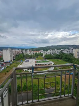 View from the balcony overlooking the neighborhood and green areas. - image 10
