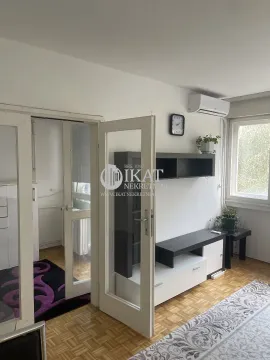 Living room with parquet flooring, furniture, and an air conditioning unit. - image 4