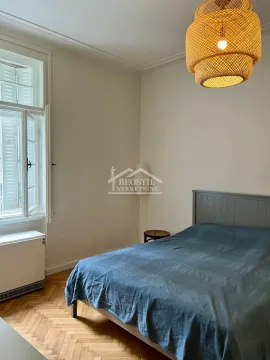 Bedroom with a double bed, wooden parquet flooring, and a window letting in natural light. - image 6