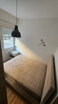 Manja spavaća soba sa bračnim krevetom, noćnim stočićem i prozorom. - image 12