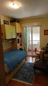 Furnished bedroom with a bed, desk, and access to the terrace. - image 8