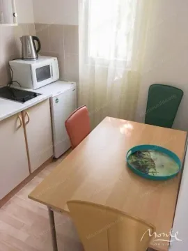 Small kitchen with a dining table and chairs. - image 14