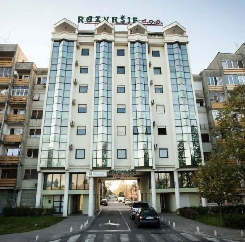 Facade of a multi-story building with glass panels.