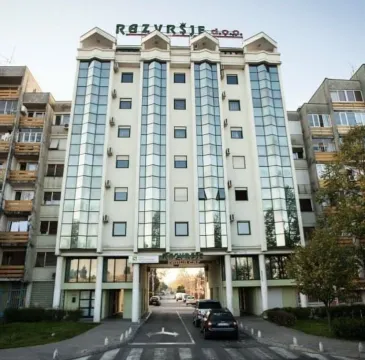 Facade of a multi-story building with glass panels. - image 7