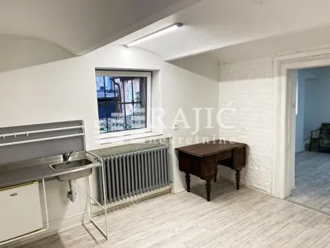 Smaller kitchen area with a sink in a room with white walls and wooden flooring. - image 4