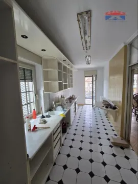 Long kitchen with a sink, cabinetry, and access to the terrace. - image 5