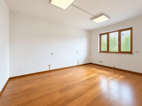 Empty bright room with wooden flooring and a window. - image 17