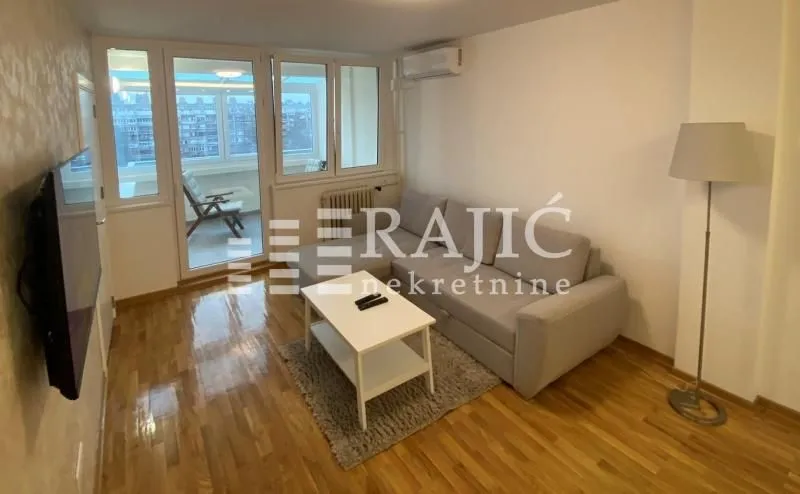 Living room with a sofa, coffee table and access to the terrace.