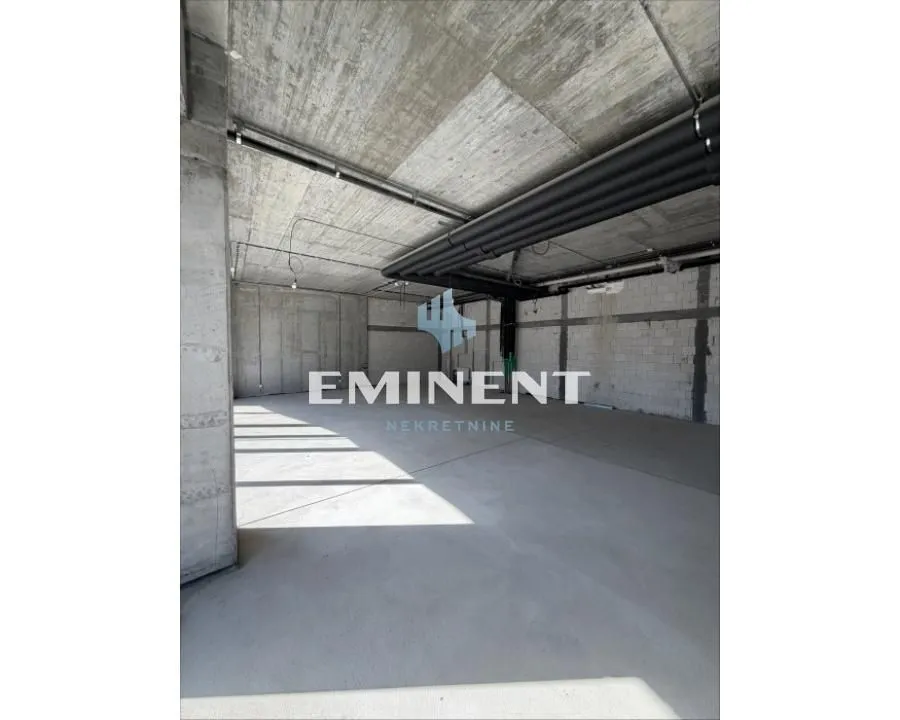 Unfinished space under construction with concrete pillars and ceiling.
